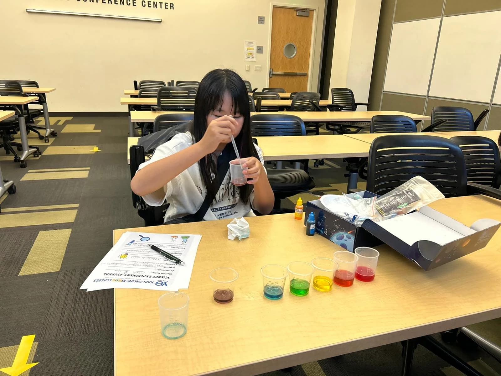 A child conducting a colorful classroom science activity