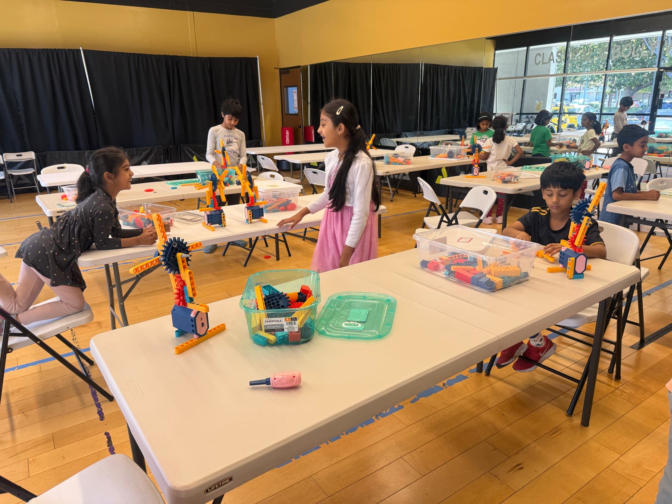 Children sharing tools and materials during a maker activity