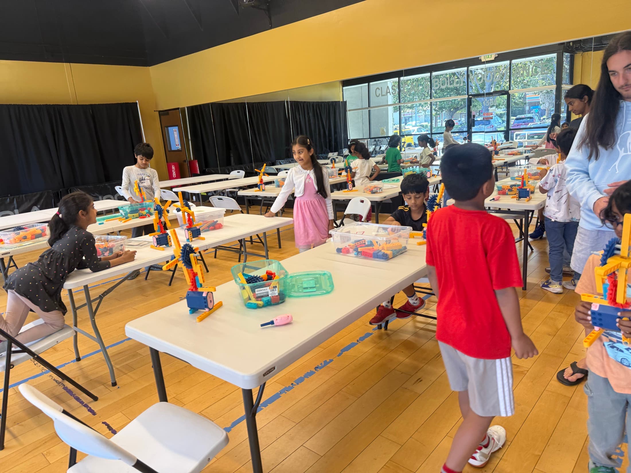 Children working at creative stations throughout the activity room